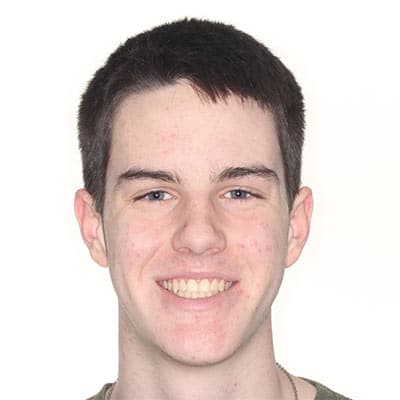 Teen smiling after treatment with straight, well-aligned teeth and a healthier, more balanced smile.