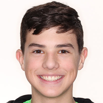 Smiling teen with straight, evenly aligned teeth and a balanced smile after orthodontic treatment