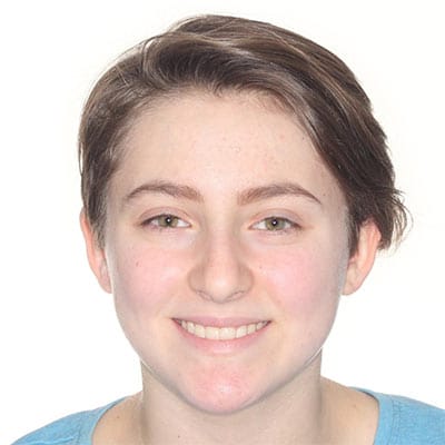 Smiling teen with straight, balanced teeth and an improved smile after orthodontic treatment.